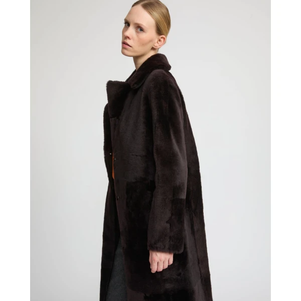 Woman wearing Yves Salomon shearling fur coat – luxury outerwear at Coveti