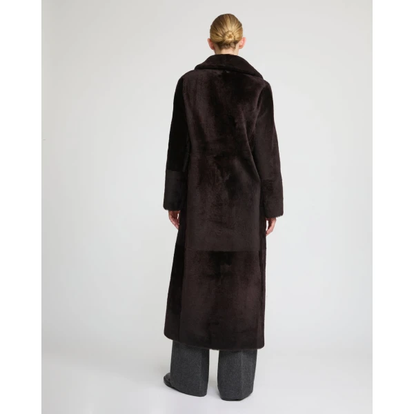 Woman wearing Yves Salomon shearling fur coat – luxury outerwear at Coveti