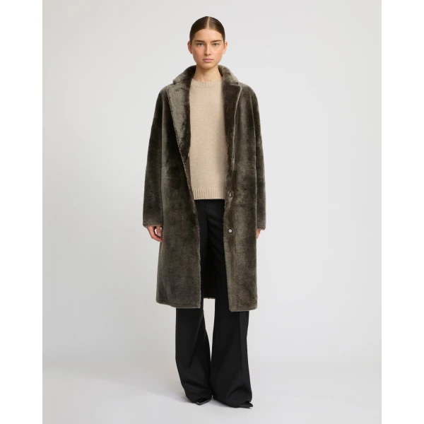 Woman wearing Yves Salomon shearling fur coat – luxury outerwear at Coveti