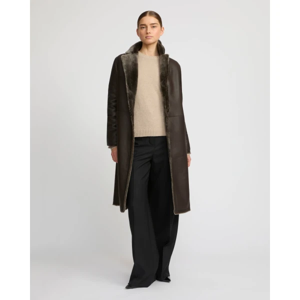 Woman wearing Yves Salomon shearling fur coat – luxury outerwear at Coveti