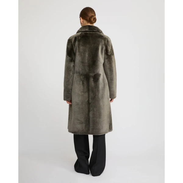 Woman wearing Yves Salomon shearling fur coat – luxury outerwear at Coveti