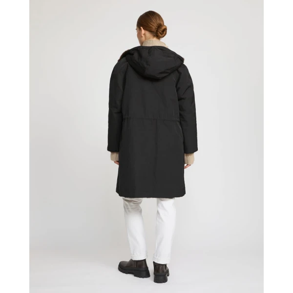 Woman wearing Yves Salomon shearling fur coat – luxury outerwear at Coveti