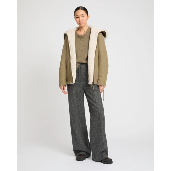 Woman wearing Yves Salomon shearling fur coat – luxury outerwear at Coveti