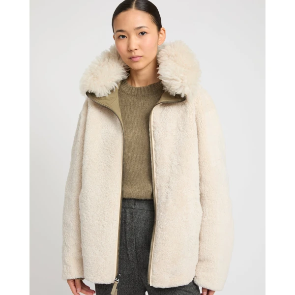Woman wearing Yves Salomon shearling fur coat – luxury outerwear at Coveti