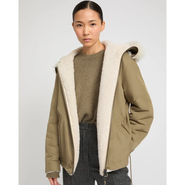 Woman wearing Yves Salomon shearling fur coat – luxury outerwear at Coveti