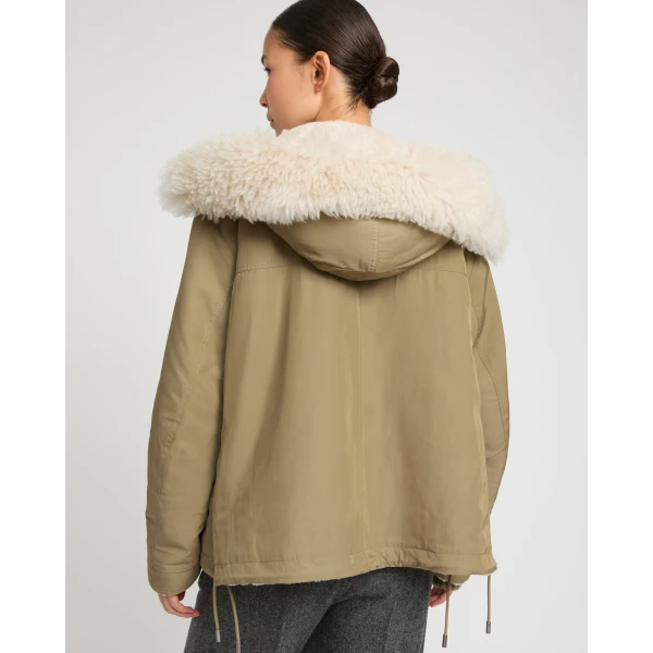 Woman wearing Yves Salomon shearling fur coat – luxury outerwear at Coveti