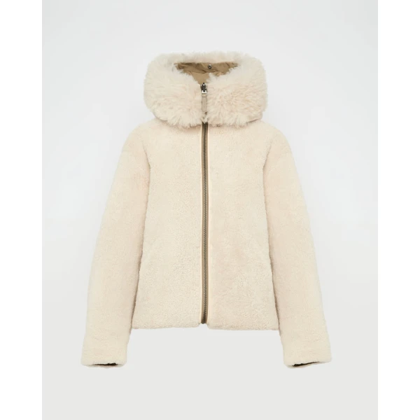 Woman wearing Yves Salomon shearling fur coat – luxury outerwear at Coveti