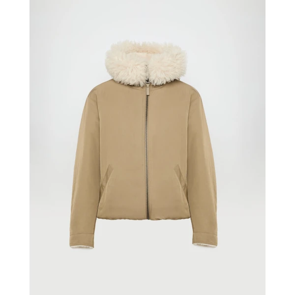 Woman wearing Yves Salomon shearling fur coat – luxury outerwear at Coveti