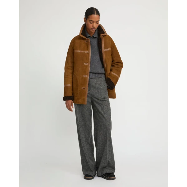 Woman wearing Yves Salomon shearling fur coat – luxury outerwear at Coveti