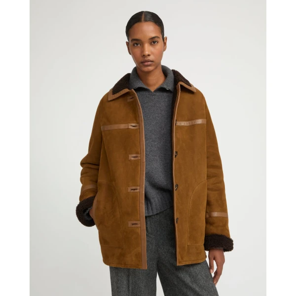 Woman wearing Yves Salomon shearling fur coat – luxury outerwear at Coveti