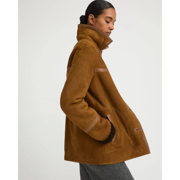 Woman wearing Yves Salomon shearling fur coat – luxury outerwear at Coveti