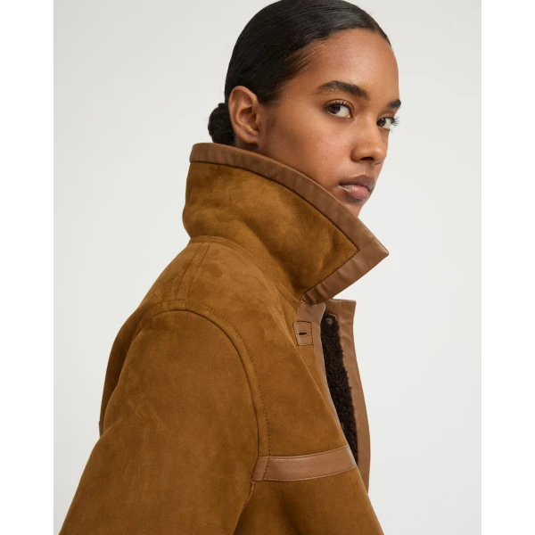Woman wearing Yves Salomon shearling fur coat – luxury outerwear at Coveti