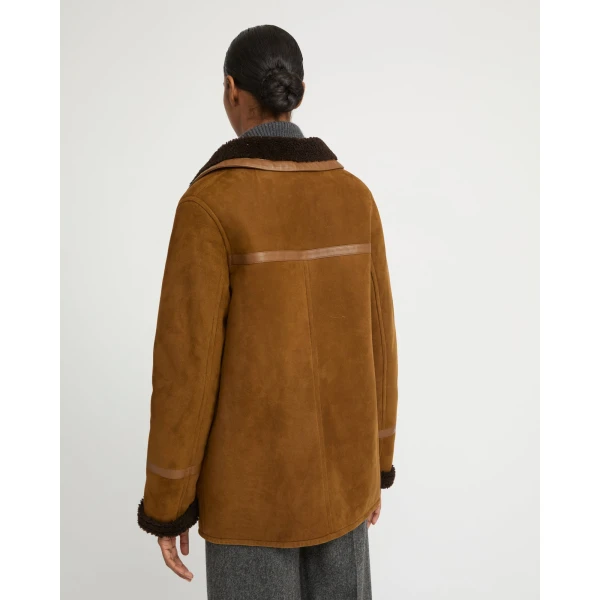 Woman wearing Yves Salomon shearling fur coat – luxury outerwear at Coveti