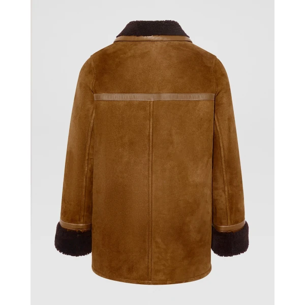 Woman wearing Yves Salomon shearling fur coat – luxury outerwear at Coveti