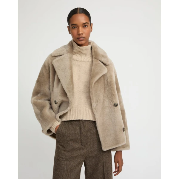 Woman wearing Yves Salomon shearling fur coat – luxury outerwear at Coveti