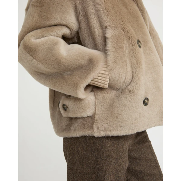 Woman wearing Yves Salomon shearling fur coat – luxury outerwear at Coveti