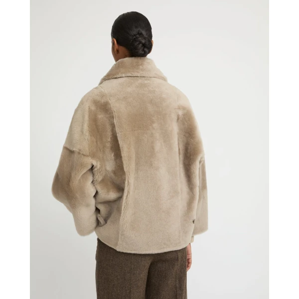 Woman wearing Yves Salomon shearling fur coat – luxury outerwear at Coveti