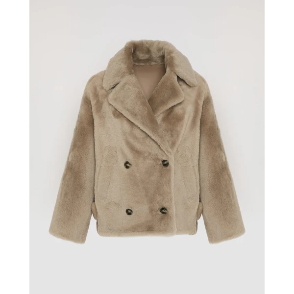 Woman wearing Yves Salomon shearling fur coat – luxury outerwear at Coveti