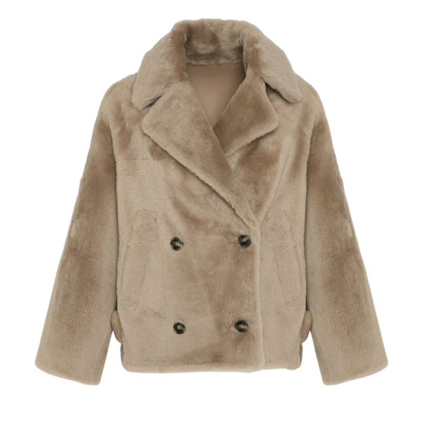 Woman wearing Yves Salomon shearling fur coat – luxury outerwear at Coveti