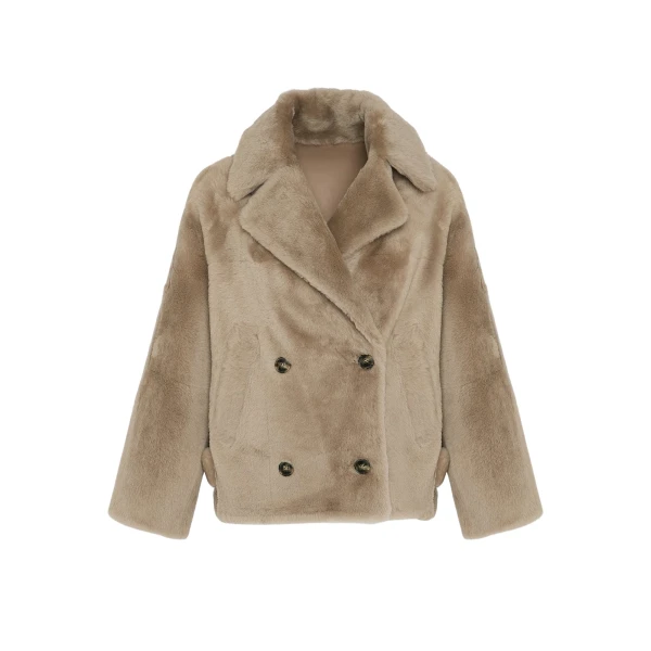 Woman wearing Yves Salomon shearling fur coat – luxury outerwear at Coveti