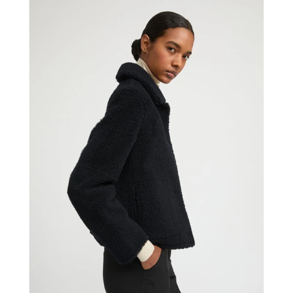 Woman wearing Yves Salomon shearling fur coat – luxury outerwear at Coveti