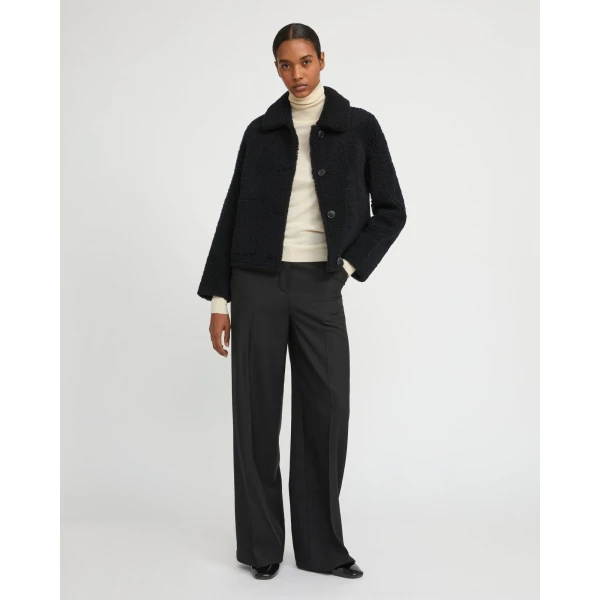 Woman wearing Yves Salomon shearling fur coat – luxury outerwear at Coveti