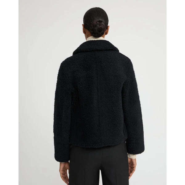 Woman wearing Yves Salomon shearling fur coat – luxury outerwear at Coveti