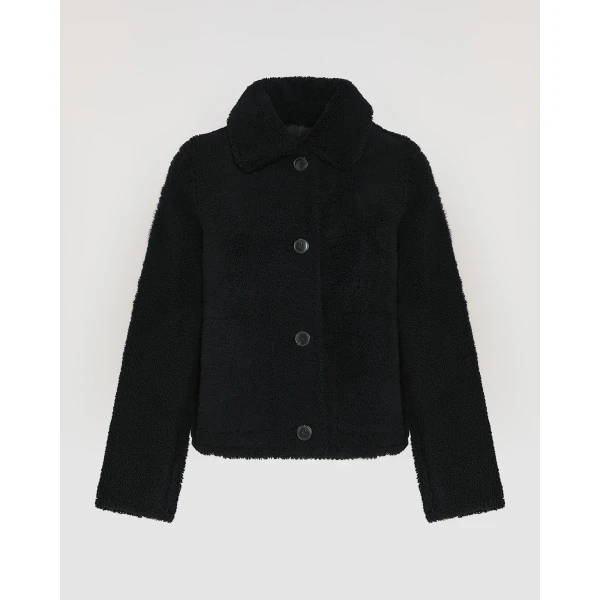 Woman wearing Yves Salomon shearling fur coat – luxury outerwear at Coveti
