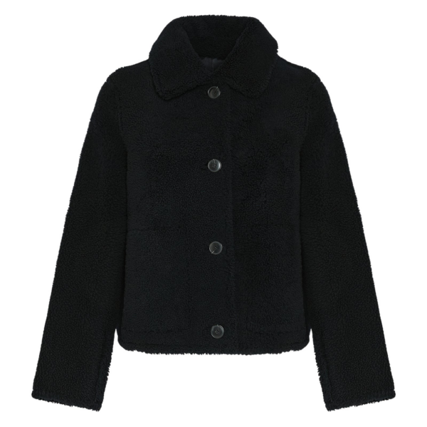 Woman wearing Yves Salomon shearling fur coat – luxury outerwear at Coveti