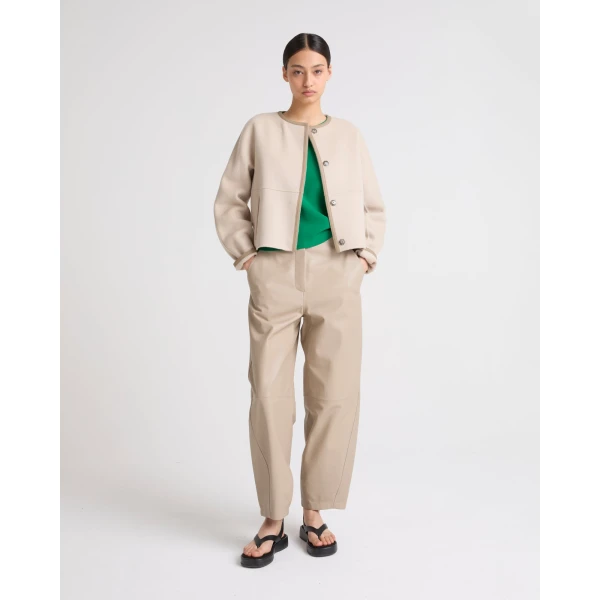 Woman wearing Yves Salomon shearling fur coat – luxury outerwear at Coveti