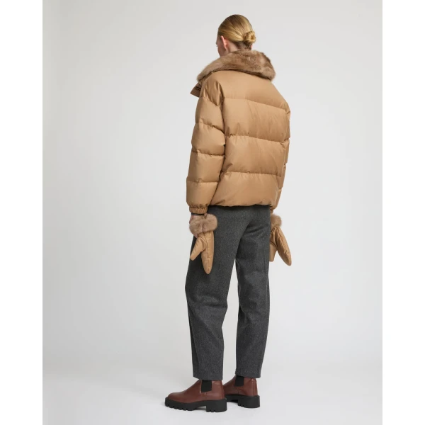 Woman wearing Yves Salomon shearling fur coat – luxury outerwear at Coveti