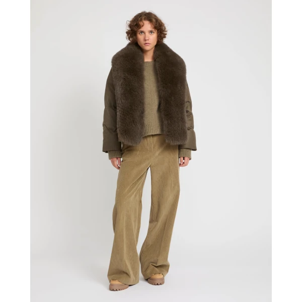 Woman wearing Yves Salomon shearling fur coat – luxury outerwear at Coveti