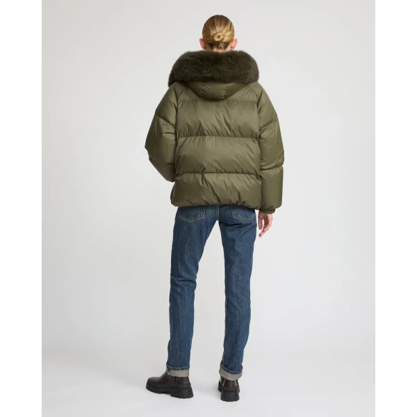Woman wearing Yves Salomon shearling fur coat – luxury outerwear at Coveti
