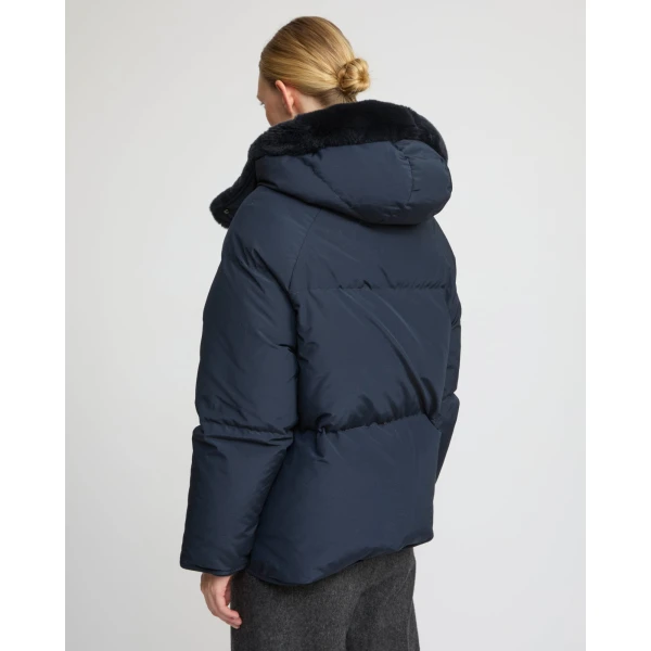 Woman wearing Yves Salomon shearling fur coat – luxury outerwear at Coveti