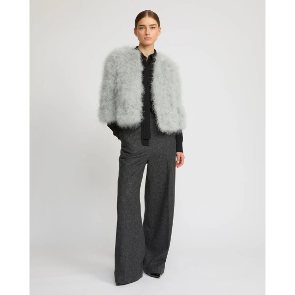 Woman wearing Yves Salomon shearling fur coat – luxury outerwear at Coveti