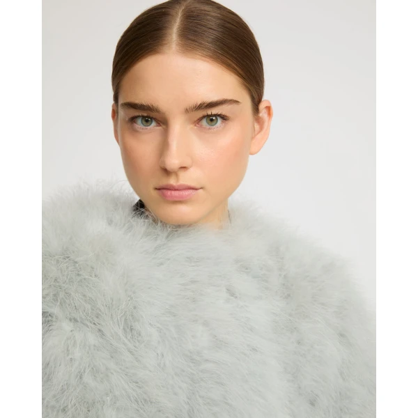 Woman wearing Yves Salomon shearling fur coat – luxury outerwear at Coveti