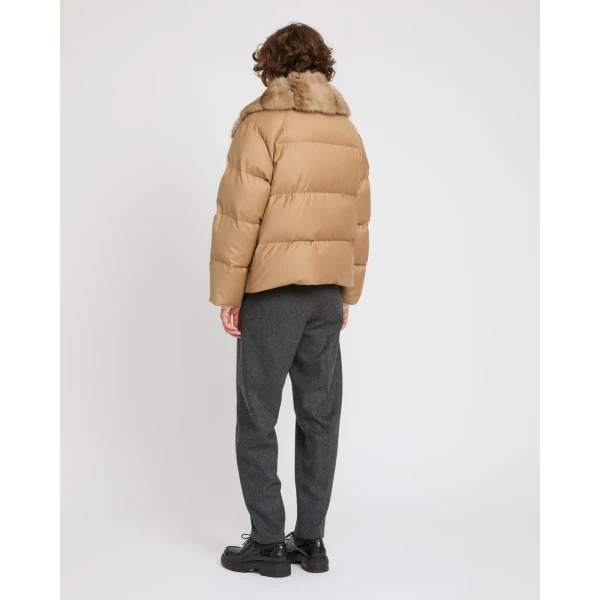 Woman wearing Yves Salomon shearling fur coat – luxury outerwear at Coveti