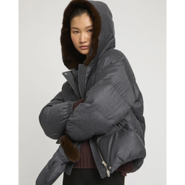 Woman wearing Yves Salomon shearling fur coat – luxury outerwear at Coveti