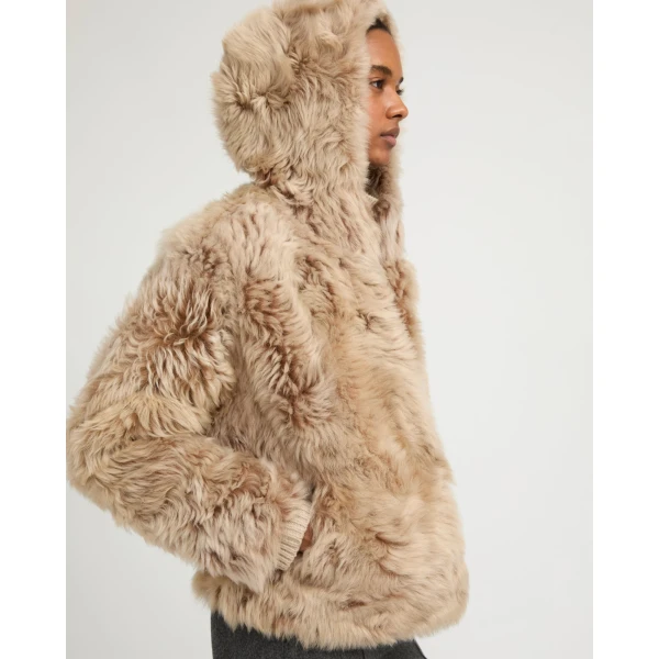 Woman wearing Yves Salomon shearling fur coat – luxury outerwear at Coveti