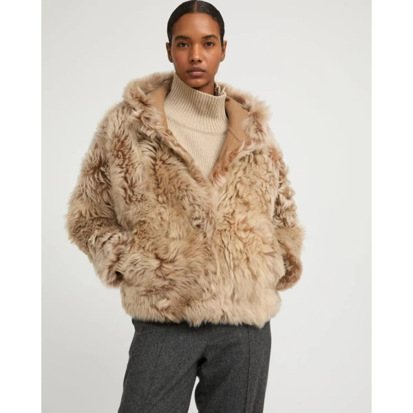 Woman wearing Yves Salomon shearling fur coat – luxury outerwear at Coveti