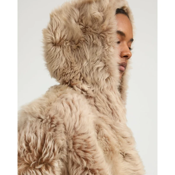 Woman wearing Yves Salomon shearling fur coat – luxury outerwear at Coveti