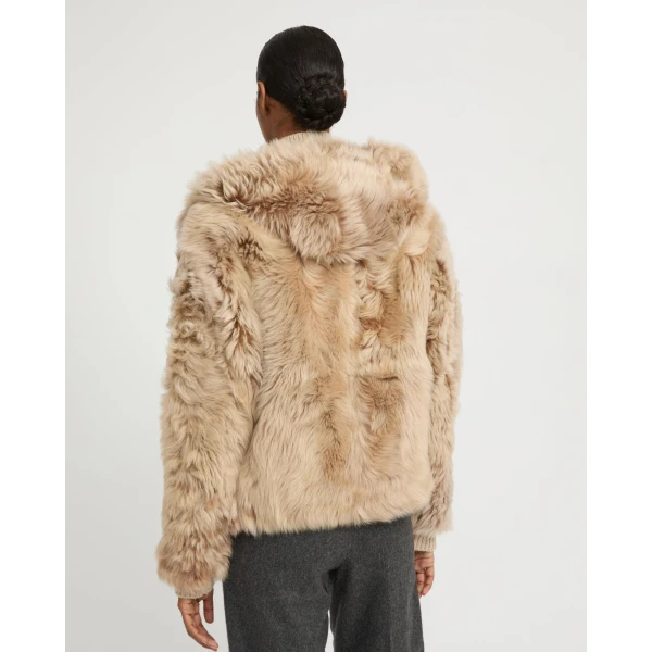 Woman wearing Yves Salomon shearling fur coat – luxury outerwear at Coveti
