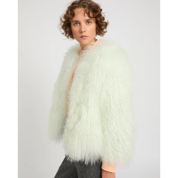 Woman wearing Yves Salomon shearling fur coat – luxury outerwear at Coveti