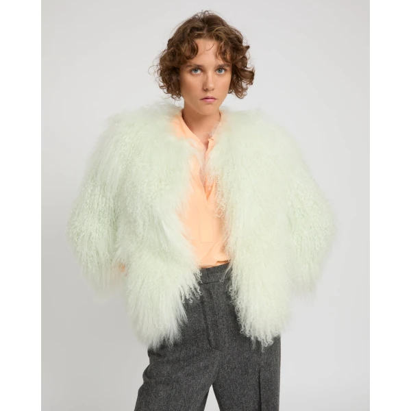 Woman wearing Yves Salomon shearling fur coat – luxury outerwear at Coveti