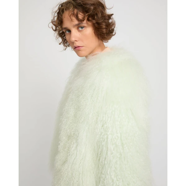Woman wearing Yves Salomon shearling fur coat – luxury outerwear at Coveti