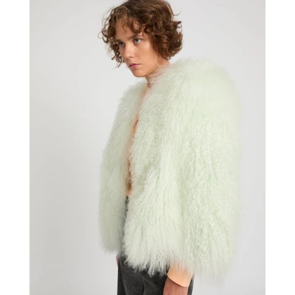 Woman wearing Yves Salomon shearling fur coat – luxury outerwear at Coveti