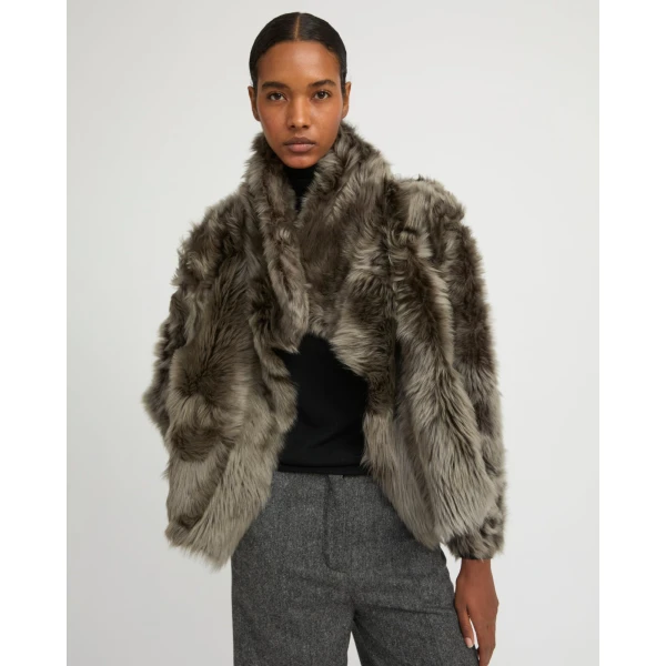 Woman wearing Yves Salomon shearling fur coat – luxury outerwear at Coveti