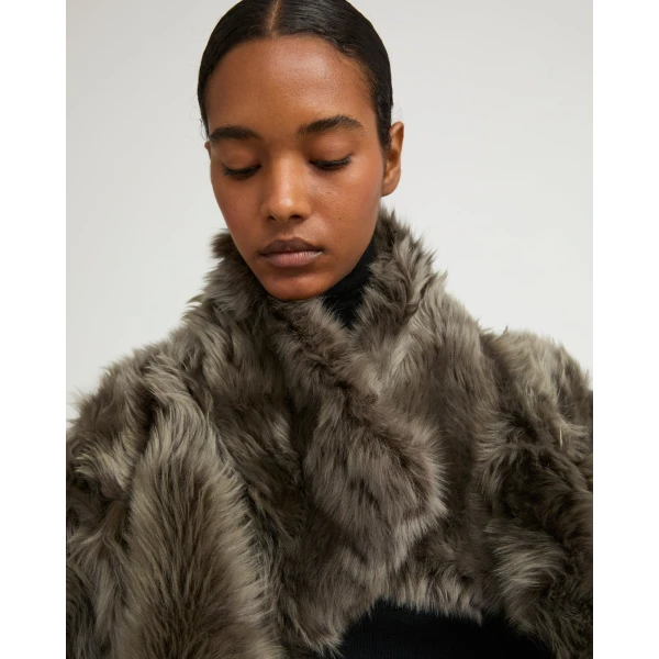 Woman wearing Yves Salomon shearling fur coat – luxury outerwear at Coveti