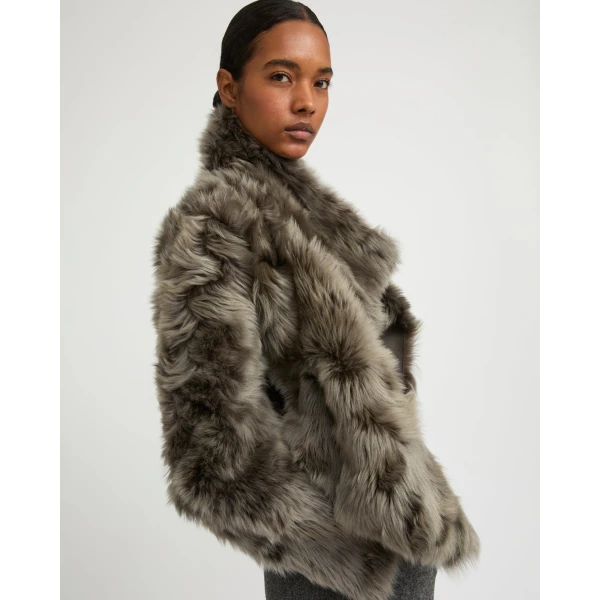 Woman wearing Yves Salomon shearling fur coat – luxury outerwear at Coveti