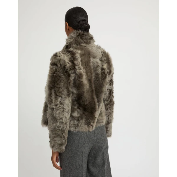 Woman wearing Yves Salomon shearling fur coat – luxury outerwear at Coveti